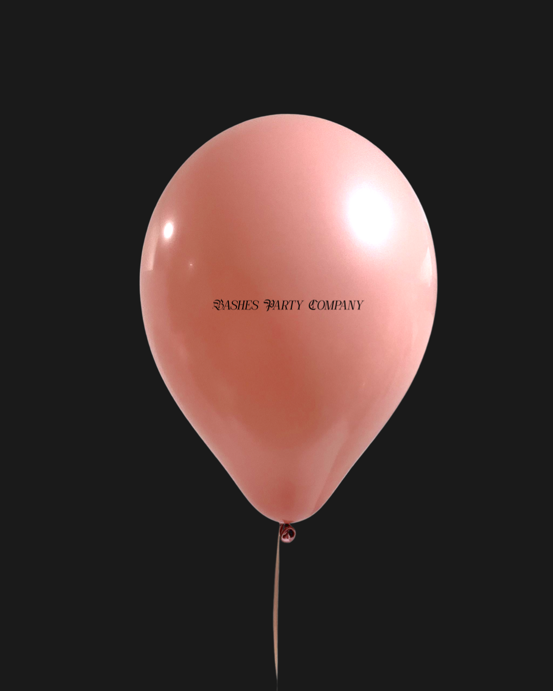 Pink balloon with 'Bashesl Party Company' text on a black background