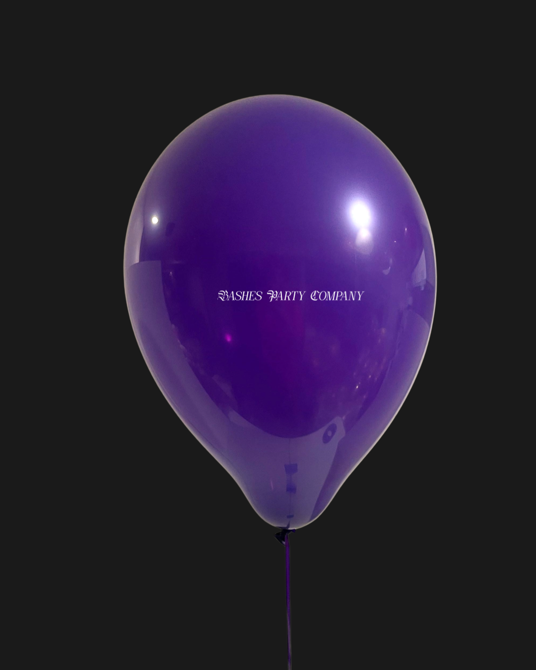 Purple balloon with 'Bashes Party Company' text on a black background
